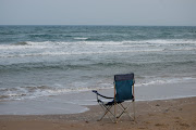 Abandoned chair. My guess is was so visually perfect the sitter just . (south padre island )