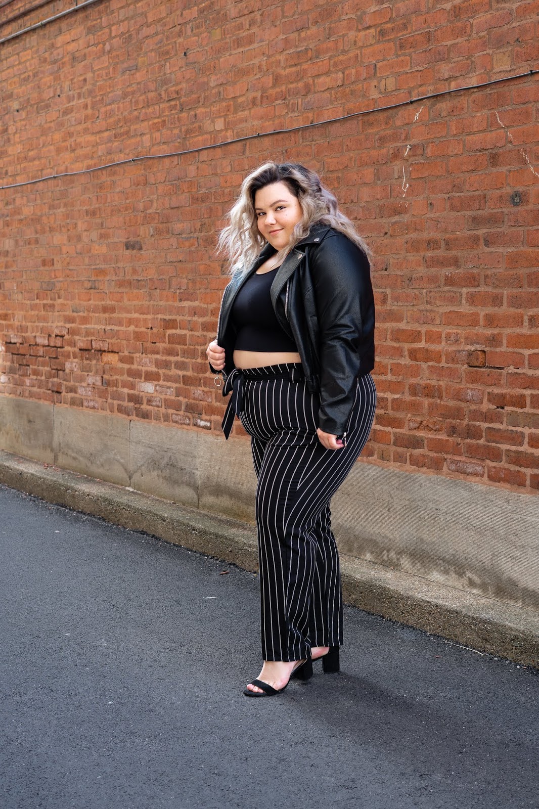 Chicago Plus Size Petite Fashion Blogger, YouTuber, and model Natalie Craig, of Natalie in the City, reviews Fashion Nova's paper bag waist pants and cropped tops.