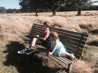boy with autism and girl sitting on a bench