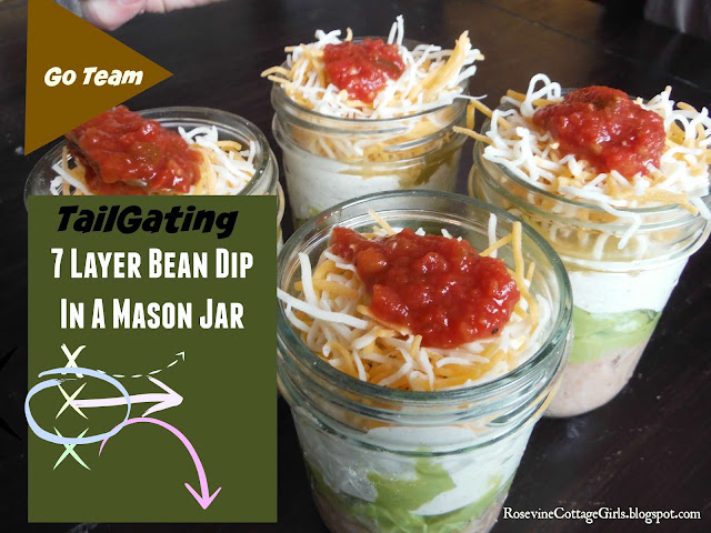 Photo of Mason Jars filled with seven layer bean dip for on the go eating. This is from an article tailgating recipes by rosevinecottagegirls.com