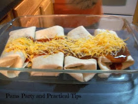 Adding the cheese on the top of the burritos