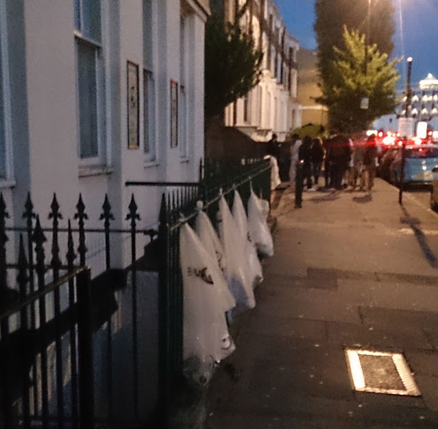 Bin bags on railings in Grove road during Lovebox