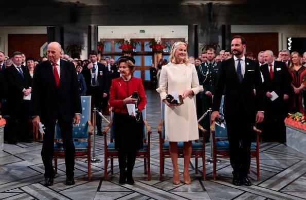 Crown Princess Mette-Marit wore a wool-cashmere ivory coat by Valentino and Prada gold headband. Queen Sonja