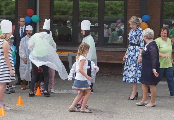 Queen Mathilde visits Playground Space summer camp in Zoutleeuw. The Queen wore Natan blue print midi shift dress