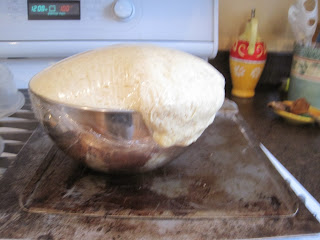 Dough rising up and over the edge of the bowl