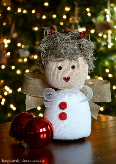 Christmas Sock Doll completed in front of a tree