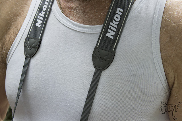 man with camera straps