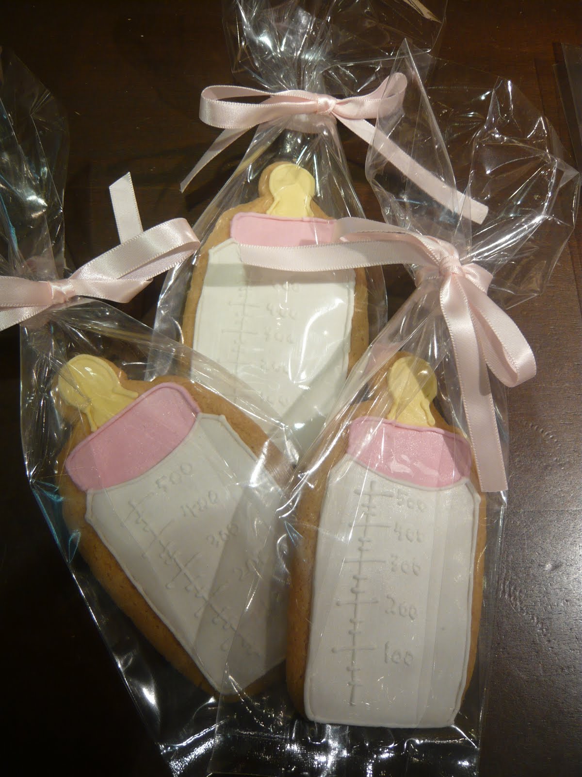 Sift Baby girl milk bottle cookie party favors
