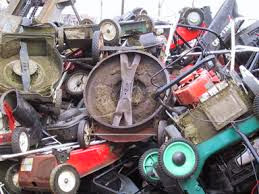 lawnmowers stacked up in the landfill