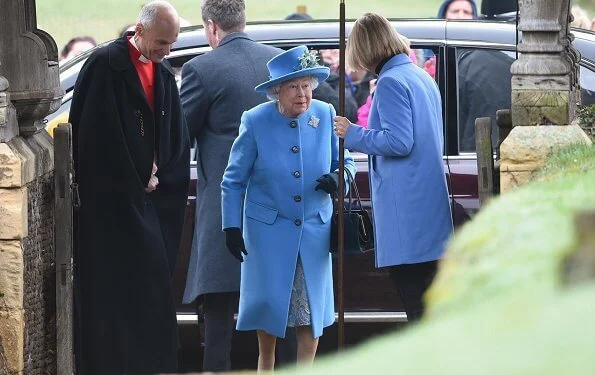 Queen Elizabeth wears her Canadian snowflake brooch. This Sapphire brooch was given to the Queen on behalf of the Canadian people