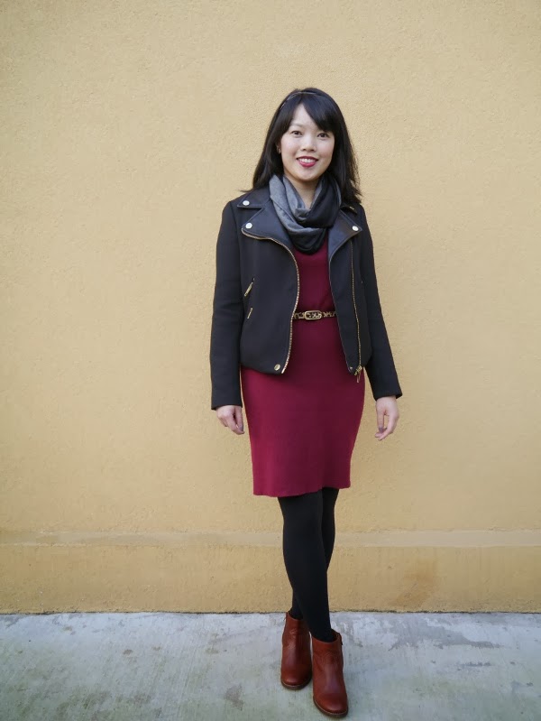 Vancouver blogger Lisa Wong of Solo Lisa wears a black moto jacket, black/grey colourblocked jersey scarf, burgundy sweater dress, leopard print belt, black tights, and cognac leather booties.