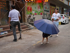 a large umbrella with the legs of a kid underneath in Zhuhai, China
