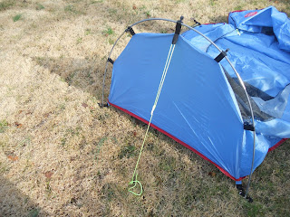 Run the clew and guy rope through the tab at the rear of tent