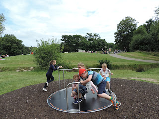 kids pushing a roundabout in play park southampton common tegan victoria bree