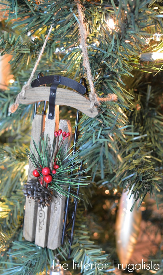 An adorable wood and metal sleigh ornament