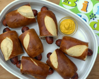 Fun Pretzel Roll Hot Dogs, just hot dogs in Trader Joe's soft pretzel sticks. Easy-easy, make-ahead, then reheat in oven, microwave or over a campfire. #KitchenParade