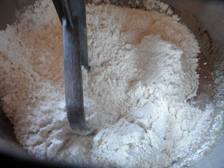 Whole Wheat Pastry Flour added to cake batter in a mixing bowl with a batter paddle.