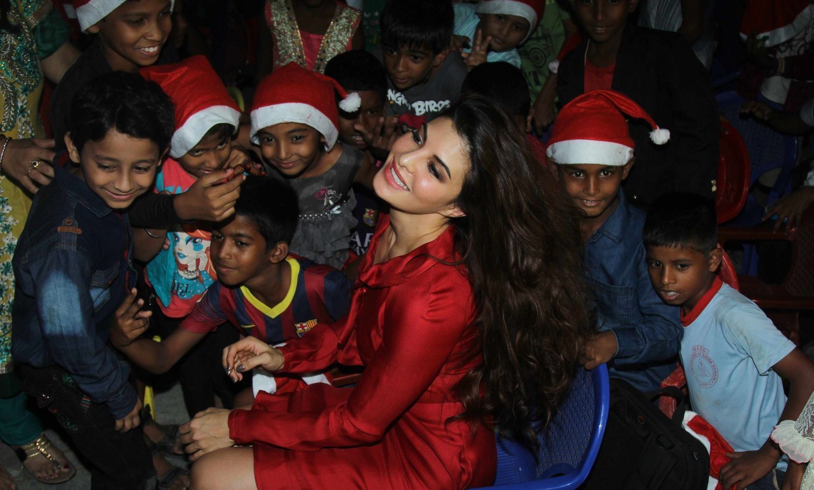 Jacqueline Fernandez Looks Super Sexy In Red Dress As She Celebrates Christmas With The Angel Xpress Foundation in Mumbai
