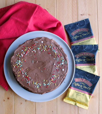 whole frosted chocolate mayo cake with packages of door county coffee