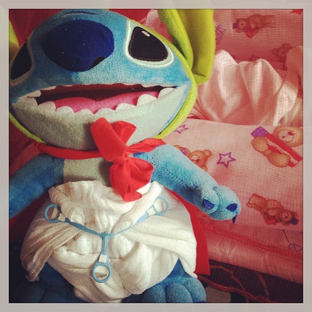Practicing pre-fold cloth diapers on Stitch! He He He