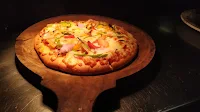 Pizza serving in a wooden spoon pizza Recipe