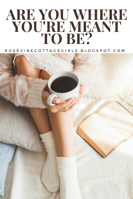Are you where you're meant to be ? Picture of a woman on a bed with her bible holding a mug of coffee reading.