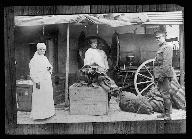 Miss Robia Whedon, Dr. McCarthy and Serbian Helper, with disinfection machine formerly used by Germans