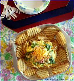 Breakfast Nachos: eggs, Canadian Bacon, spinach and more served over waffle fries for a fun and hearty breakfast to share. | Recipe developed by www.BakingInATornado.com | #recipe #breakfast