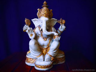 Lord Ganesha Mini Statue On The Table With Blue Background