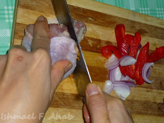 Slicing chicken meat for ginataang kalabasa