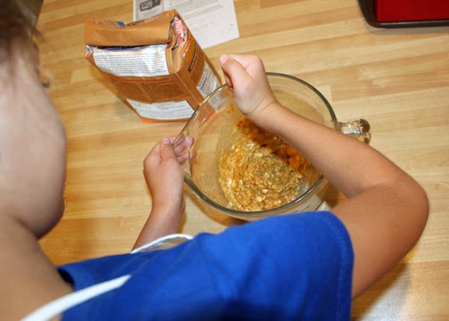After adding peanut better, oatmeal, whole wheat flour and an egg to the mashed bananas, Tessa stirred and stirred.
