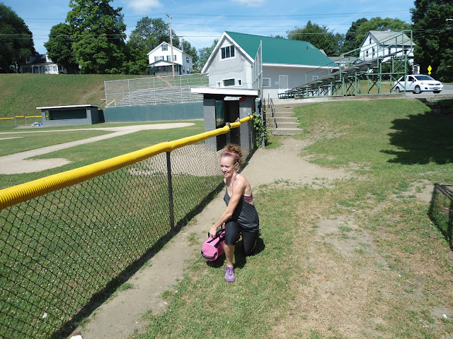 Woman doing walking weighted lunges using The Ultimate Sandbag in a twisting motion to work her core