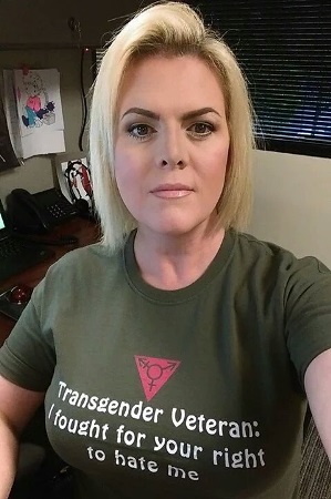 Image description: woman wearing a t-shirt that says "Transgender Veteran: I fought for your right to hate me"