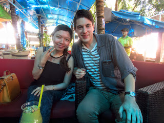 A Vietnamese girl and tourist pose at a restaurant in Dali, Vietnam