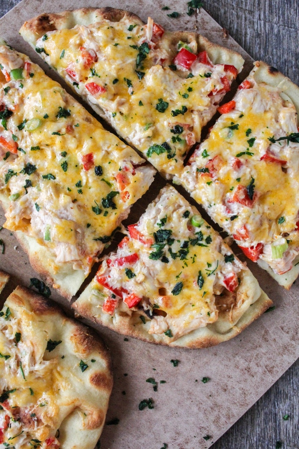 These rich and flavorful Red Chile Chicken Flatbread Pizzas come together quickly and are perfect for tailgating or as an easy weeknight meal!