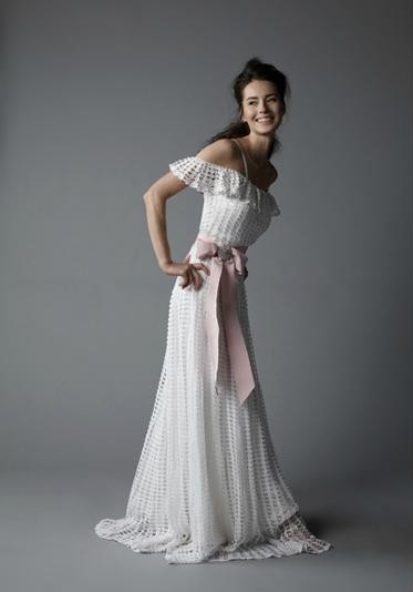 This artisanal hand crochet dress has an off the shoulder flounce and yards