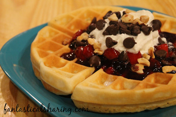 Belgian Waffle Sundaes | Fluffy waffles topped with a mixed berry sauce, whipped cream, chocolate, and macadamia nuts! #breakfast #recipe #waffles