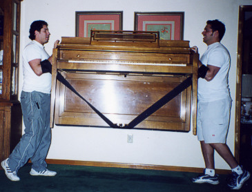 Men lifting piano
