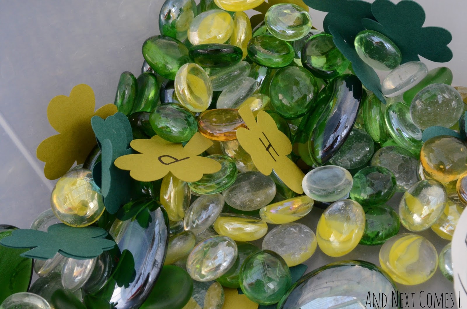 Close up of St. Patrick's Day sensory bin for kids from And Next Comes L