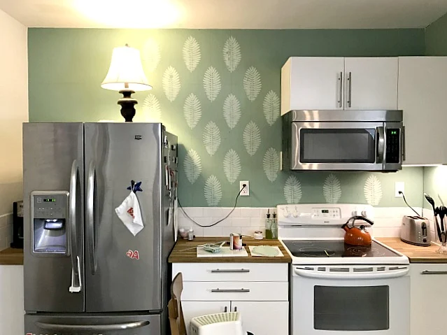 apartment kitchen with leaf designed wall
