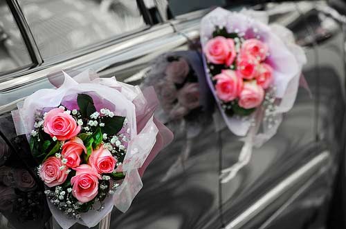 Wedding car decoration with silk flowers and ribbon