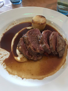beef fillet on gravy bed with potato tower 