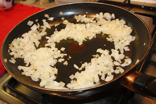 garlic and onion frying in pan for Spinach, Feta & Red Pepper Filo Quiche