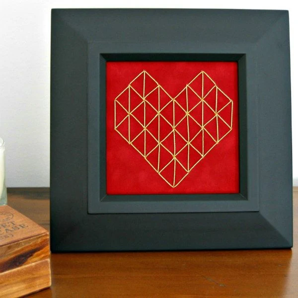 stitched geometric heart on red paper