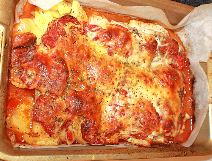 this is a pan of chicken and potatoes make like a pizza all in one pan easy meal. It is topped with mozzarella cheese and baked until crispy. Pepperoni is also added.