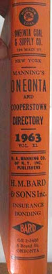 Orange spine of the book with three ads and the book title