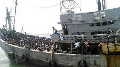 MYANMAR NAVY BLOCKS JOURNALISTS AS MIGRANT BOAT HELD IN LIMBO