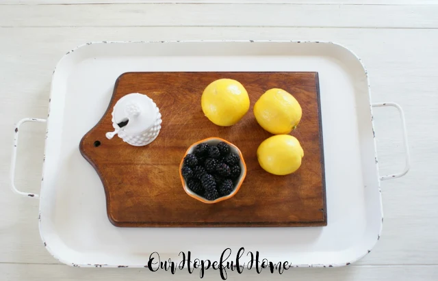 cutting board two handled white tray lemons blackberries