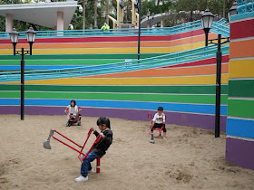 Children playing with sand scoopers at Hong Kong Park
