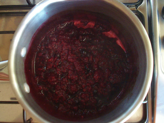 Cook the berries until the liquid is reduced and has started to thicken.